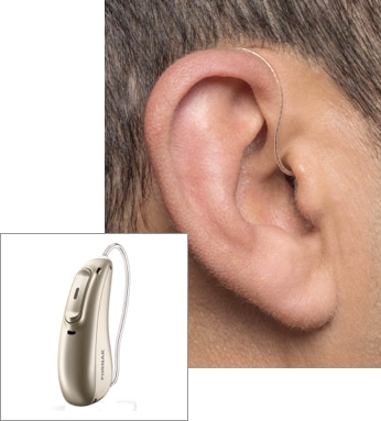 An ITE hearing aid being worn with an inset image of the device itself.