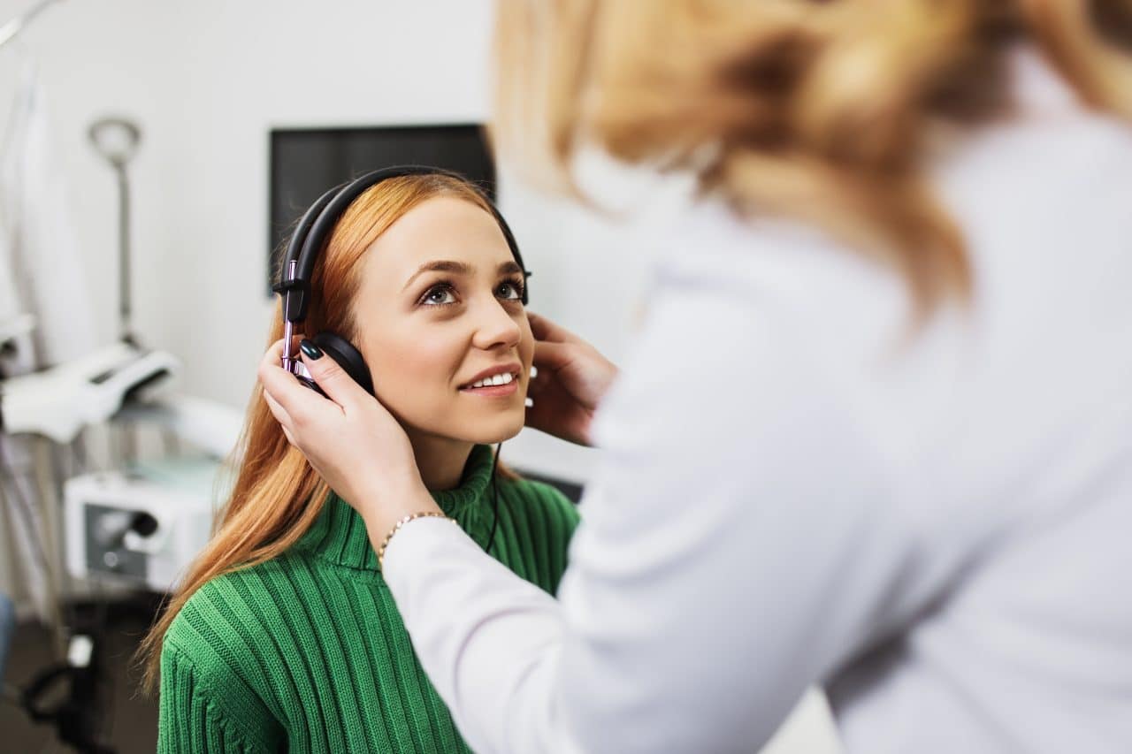 Woman gets a hearing exam.