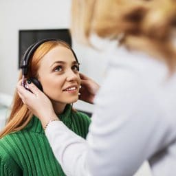Woman gets a hearing exam.