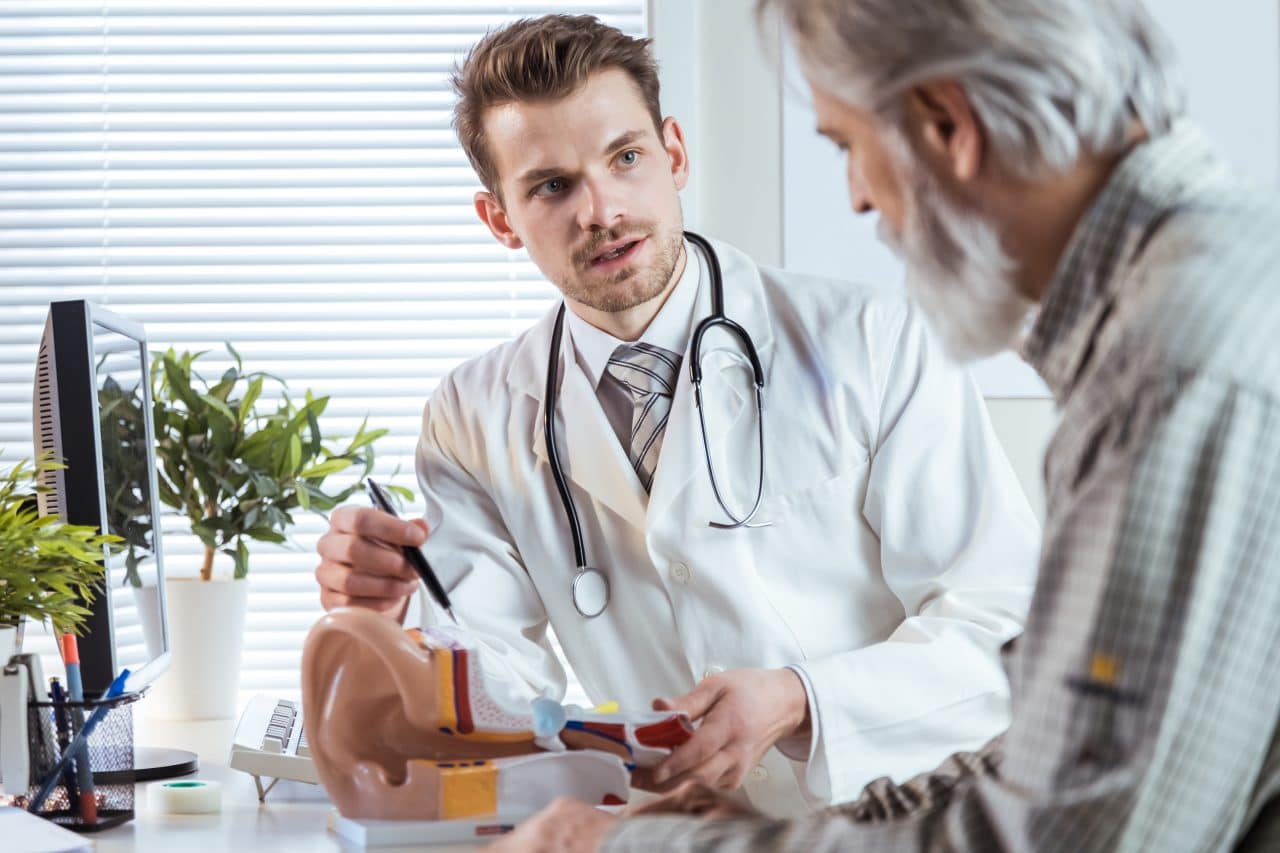 Audiologist talking to patient about hearing aids.