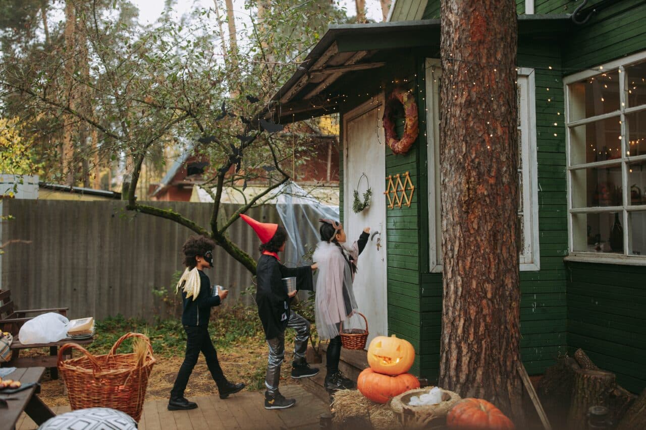 Group of kids trick-or-treating on Halloween.