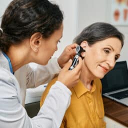 Senior woman gets an ear exam.