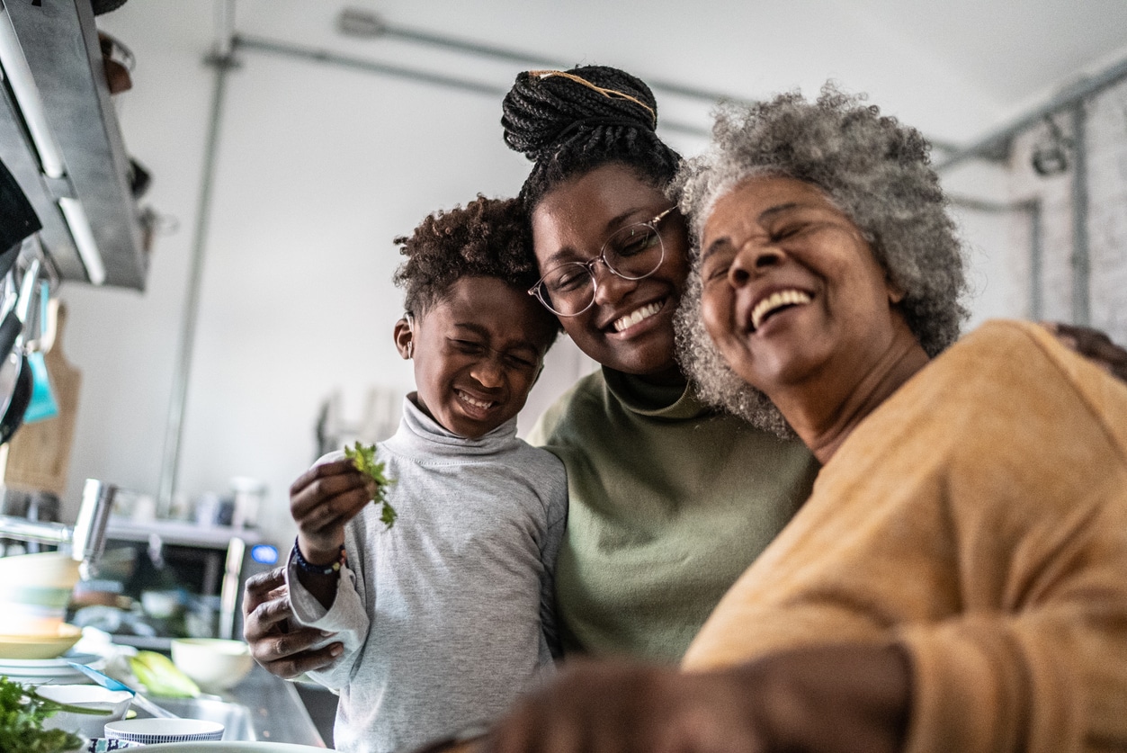 Family members hug and cook together 