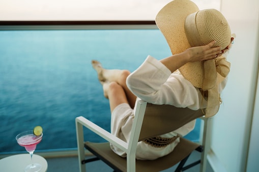 Stylish woman enjoying a cocktail on a luxurious cruise vacation.